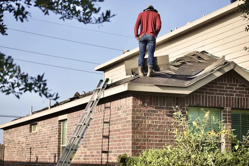 Professional roofer working on a residential roof in Brookridge North